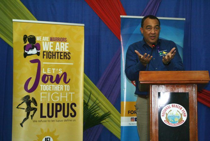 PHOTO: GARFIELD ANGUS Minister of Health and Wellness, Dr. the Hon. Christopher Tufton, addresses a recent forum in Kingston, to outline Government's support for persons living with lupus.